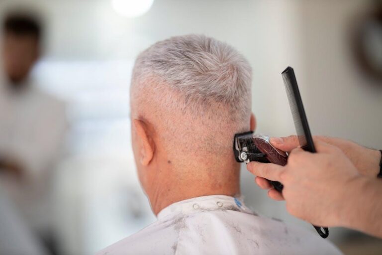 Professional barber trimming a man’s hair with a razor