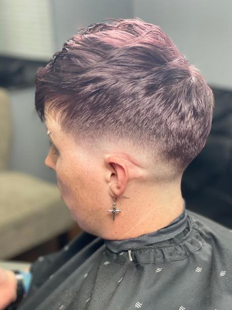 Woman sitting in a chair showing her fresh short fade haircut